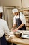 handsome bakers kneading dough together