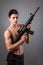 Handsome bare-chested soldier is holding a rifle