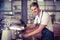 Handsome barista making a cup of coffee