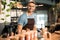 Handsome barista standing at the bar of modern cafe