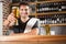 Handsome barman holding a pint of beer