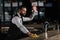 handsome bartender cleaning bar counter and waving hand