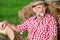 Handsome bavarian man sitting outdoors at tree stump