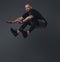 Handsome bearded athlete in sportswear jumping in a studio.