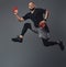 Handsome bearded athlete in sportswear jumping in a studio.