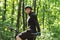 Handsome bearded cyclist looking at camera over forest background