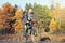 Handsome bearded hipster man in casual wear with backpack riding bicycle in autumn park or forest. Discovery beautiful fall season