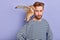 Handsome bearded man with owl on his shoulder looking at the camera