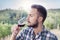 Handsome bearded man sniffs glass of wine