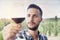 Handsome bearded man sniffs glass of wine