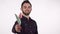 Handsome bearded romantic man holding out toy flower to the camera