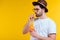 handsome bearded young man in hat and sunglasses drinking summer cocktail