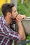 Handsome bearded young man sitting outdoors