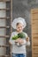 Handsome beautiful boy holding a pot full of vegetables. Healthy food. Harvest. Little chef