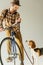 handsome bicycler with beagle with leash
