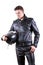 Handsome biker man wearing black leather jacket and pants holding motorcycle helmet