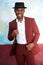 Handsome black man smiling in vintage suit and hat