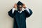 Handsome black man wearing graduation cap and ceremony robe doing funny gesture with finger over head as bull horns