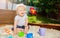 Handsome blond boy play in sandbox smiling