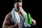 Handsome bodybuilder with towel and bottle