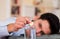 Handsome bored man holding a pill effervescent tablet in his hand ready to drop in a glass of water