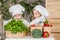 Handsome boy and beautiful young girl playing in the kitchen chefs. Healthy food. Vegetables