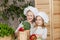 Handsome boy and beautiful young girl playing in the kitchen chefs. Healthy food. Vegetables