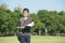 Handsome boy holding an open book, read background summer green