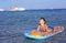 Handsome boy in swimming suit with inflatable matress on the blu