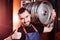 Handsome brewer man with a barrel of beer