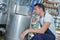 Handsome brewer in uniform at beer manufacture