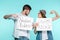 Handsome brother and pretty sister holding funny nameplates