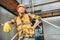 handsome builder leaning on scaffolding at construction site