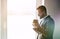 handsome businessman holding morning cup of tea or coffee, copyspace