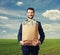 Handsome businessman holding paper bag with money