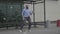 Handsome businessman starting dancing freestyle funny dance while he is happy waiting for bus in a public station -