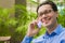 Handsome businessman talking on the phone in a cafe. young successful businessman in a shirt and tie talking on the phone in a caf