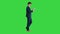 Handsome businessman walking and working on a tablet on a Green Screen, Chroma Key.