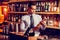 Handsome businessman wearing glasses holding bottle of whisky