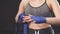Handsome caucasian blonde woman wrapping her hands with wraps for boxing