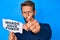 Handsome caucasian man with beard showing words have power banner pointing with finger to the camera and to you, confident gesture