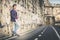 Handsome and charming young man outdoors leans against a wall in the city