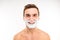 Handsome cheerful man with shaving foam on his face