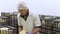 Handsome cheesemaker is checking cheeses seasoning at dairy factory in 4k UHD video.