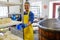 Handsome cheesemaker making curd cheese in his factory