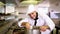 Handsome chef stirring a large pot