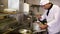 Handsome chef stirring a large pot