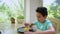 Handsome child boy enjoying a delicious snack, eating scoop-shaped mango ice cream, garnished with ripe fruits berries