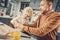 Handsome concentrated man teaching son how cooking