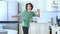 Handsome curly guy dancer cheerfully dancing at home in the kitchen